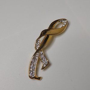 Gold Tone Ribbon Brooch With Clear Stones